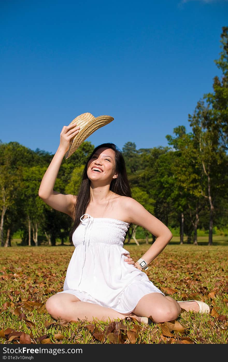 A beautiful asian girl enjoying the outdoor sun. A beautiful asian girl enjoying the outdoor sun