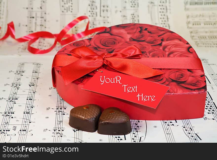 Celebrating Love - heart shaped chocolates over old classical music notes. Original RAW file available. Celebrating Love - heart shaped chocolates over old classical music notes. Original RAW file available