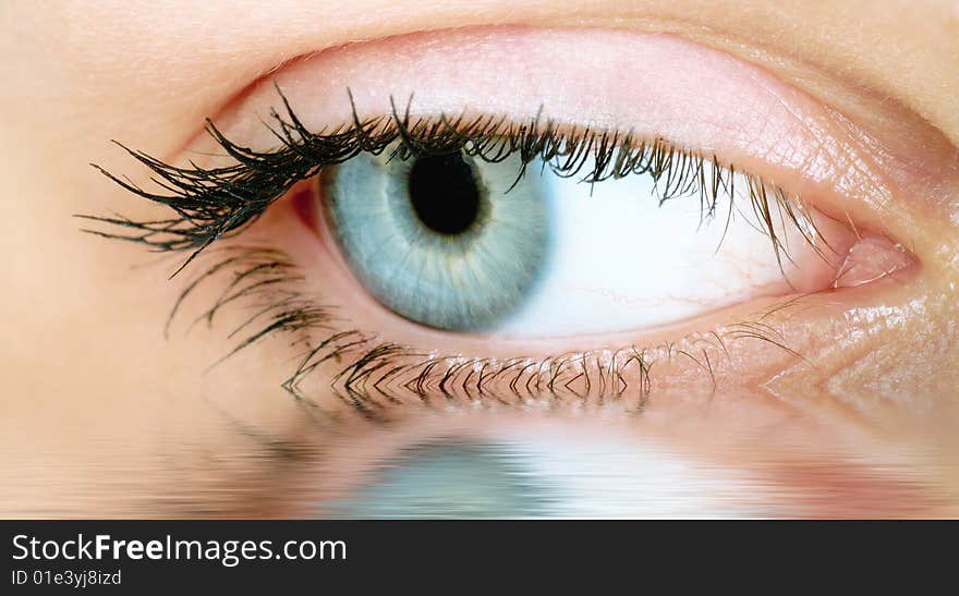 Beautiful woman eyes reflected in the water. Beautiful woman eyes reflected in the water