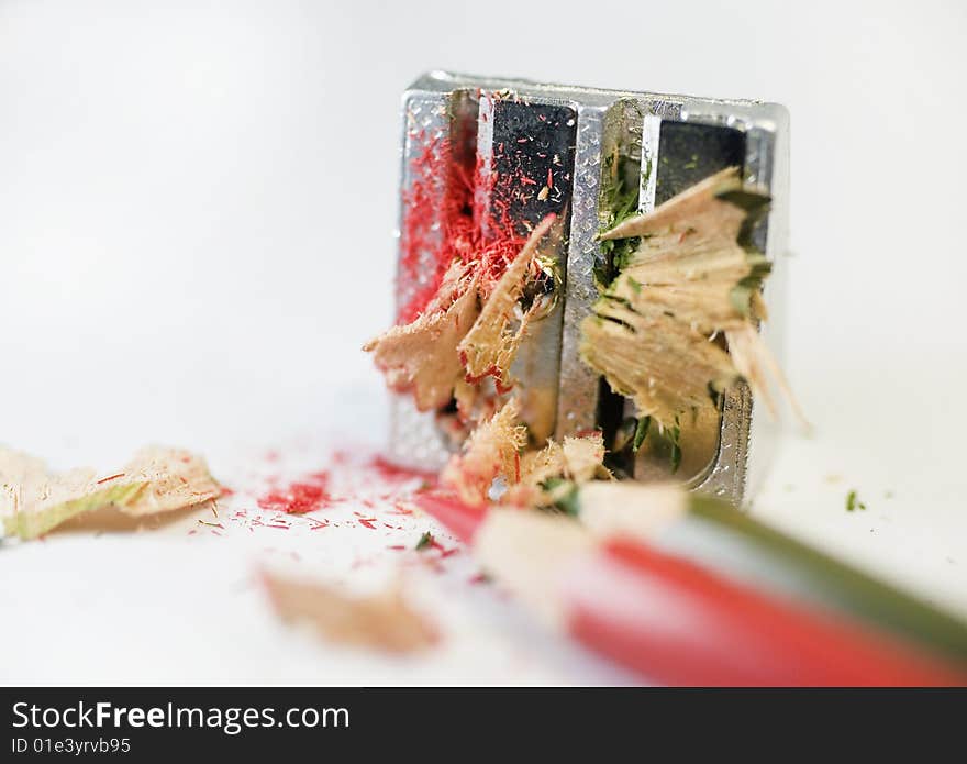 Pencil sharpener with flakes and pencil. Pencil sharpener with flakes and pencil.