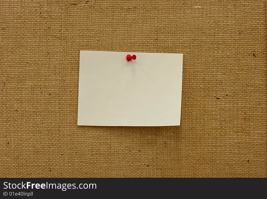 A brown sack textured, with a pinned paper. A brown sack textured, with a pinned paper.