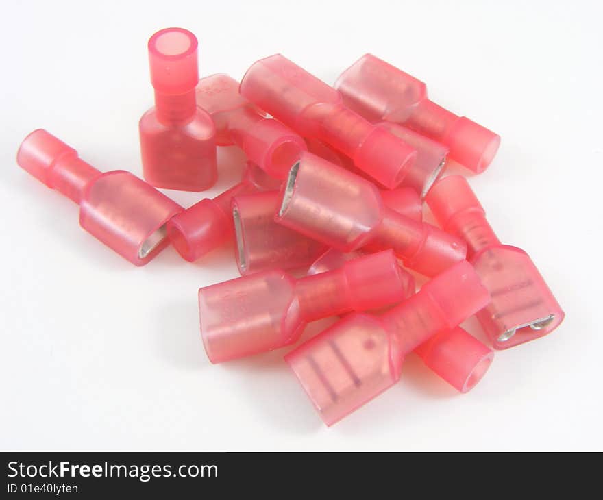 Red crimp on style electrical connectors on plain white background. Red crimp on style electrical connectors on plain white background