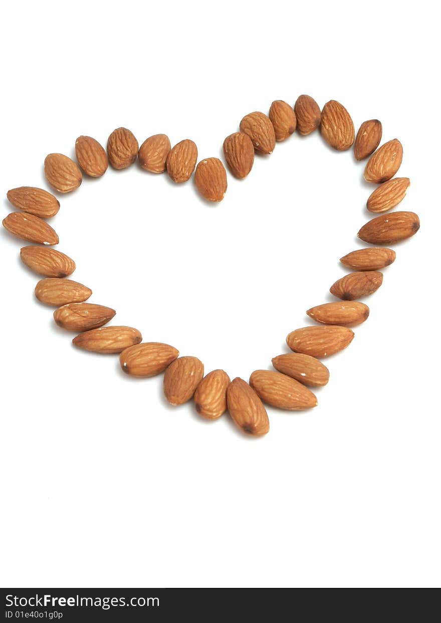 Heart made of nuts of almonds on a white background