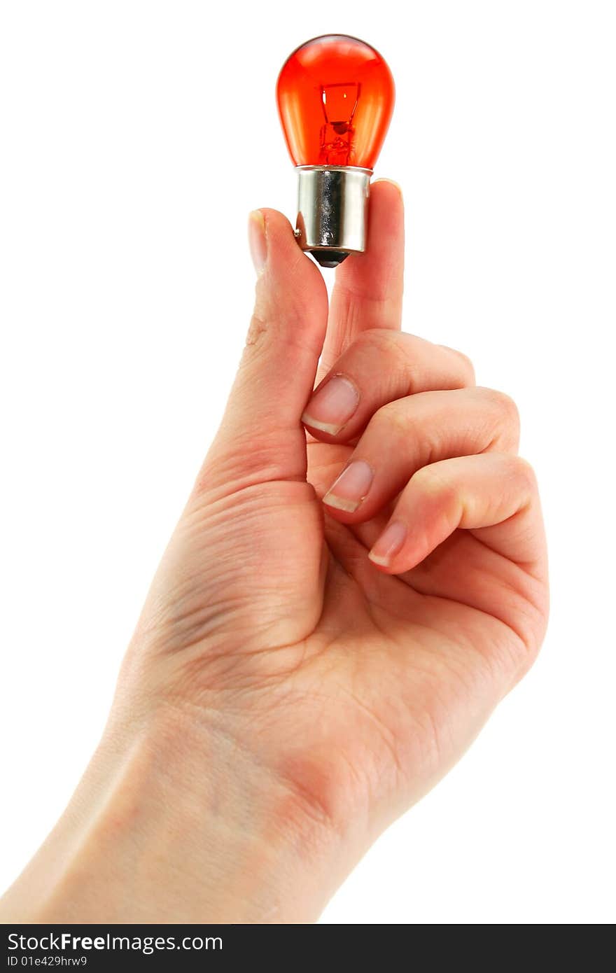 Female hand holds medical orange light bulb isolated on a white background