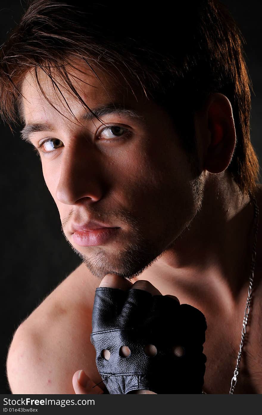 Portrait of young man. studio shot. black background.