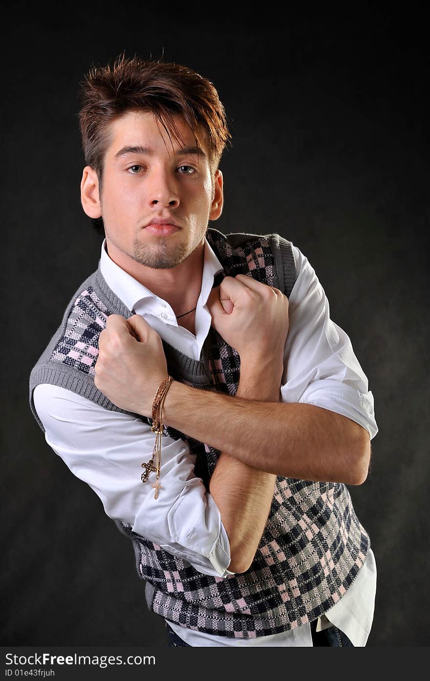 Man standing in aggresive pose. Black background. Studio shot.