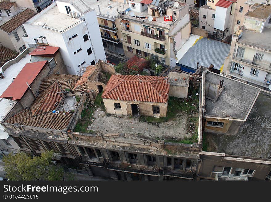 City panorama with little house standing on the roof of big building. City panorama with little house standing on the roof of big building