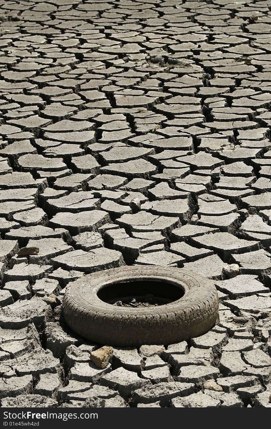 Cracked Ground Whit Tire. Global Warming Concept