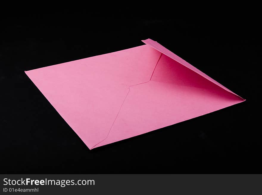 Pink envelope isolated on black background