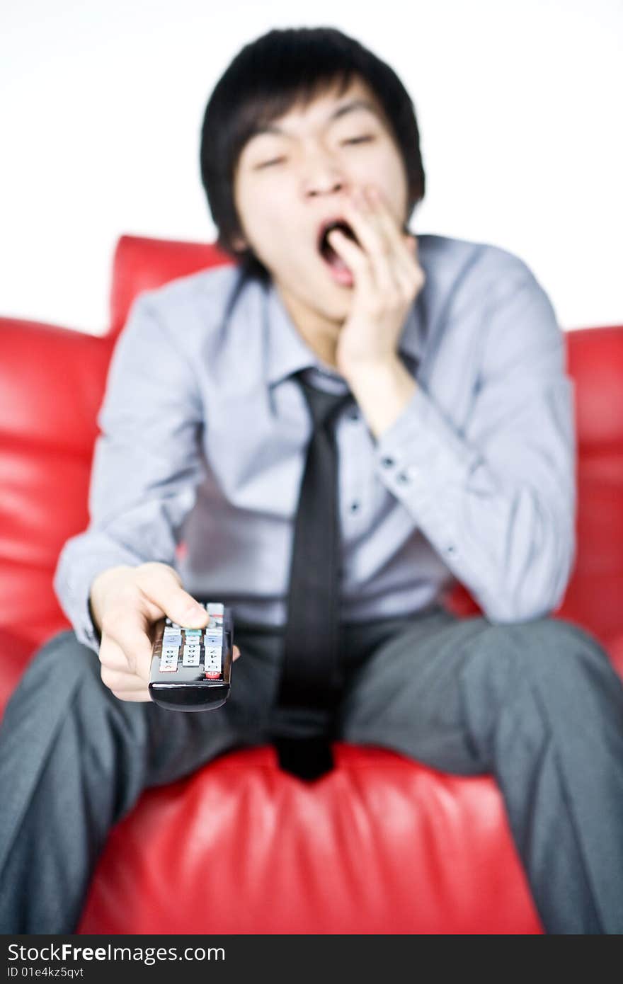 The Tired Young Man In A Grey Shirt Watches TV