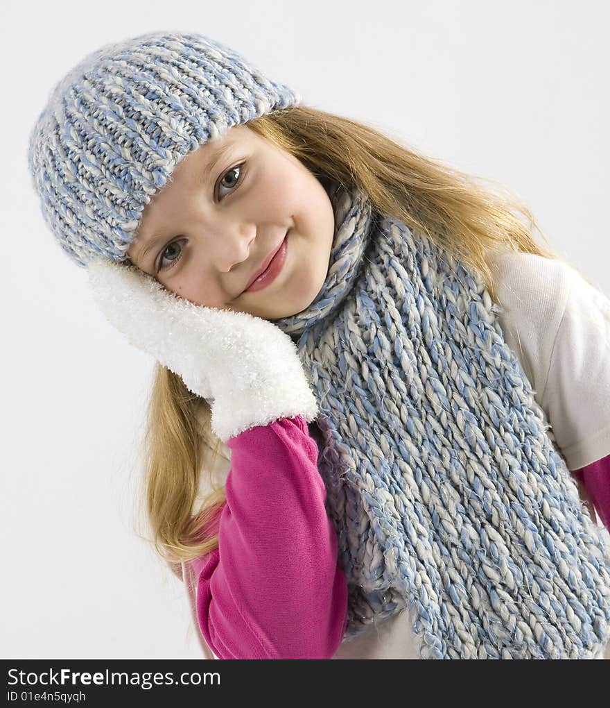 Happy young girl with cap and gloves