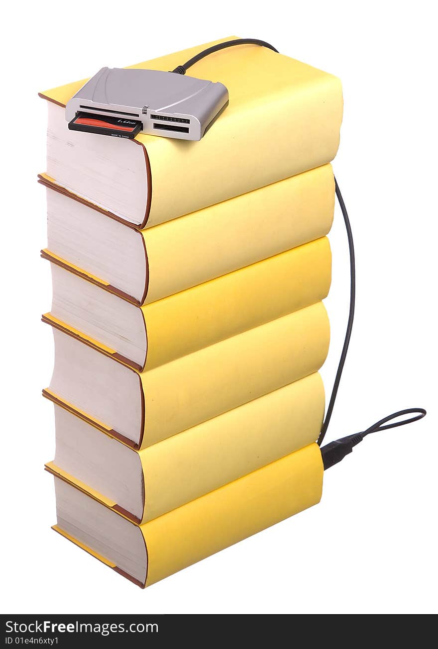 Yellow hardback books with a compact flash card reader isolated on a white background