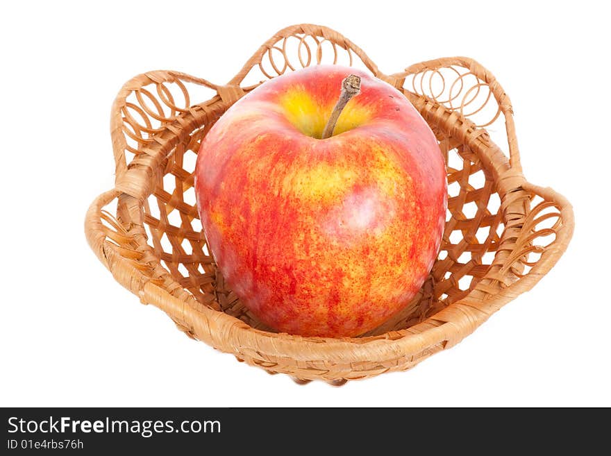 A large red apple is in a basket, on a white background