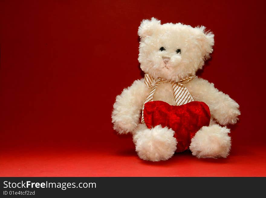 Cute teddybear holding a heart. Valentine's Day image.