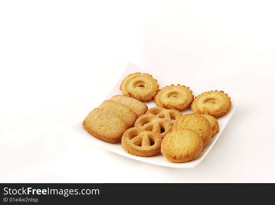 Close-up of cookies in a white plate wiith white background.