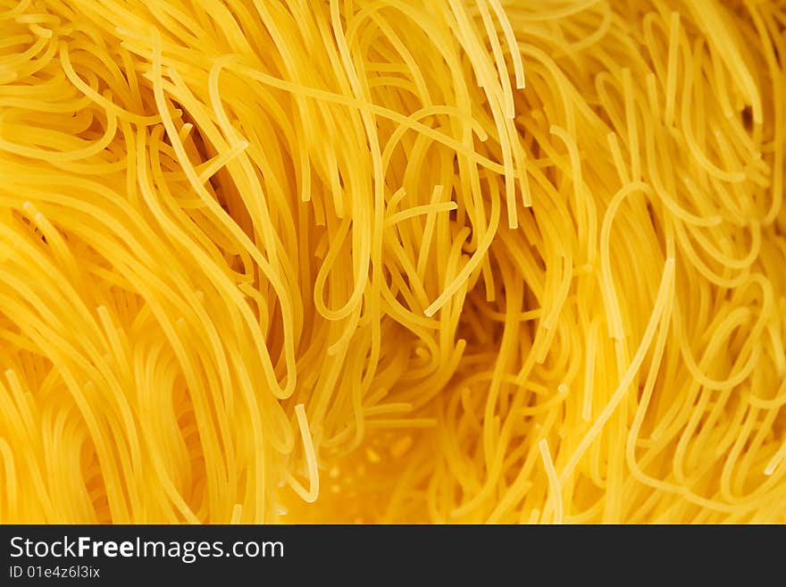 Yellow and beautiful pasta close-up as a background. Yellow and beautiful pasta close-up as a background