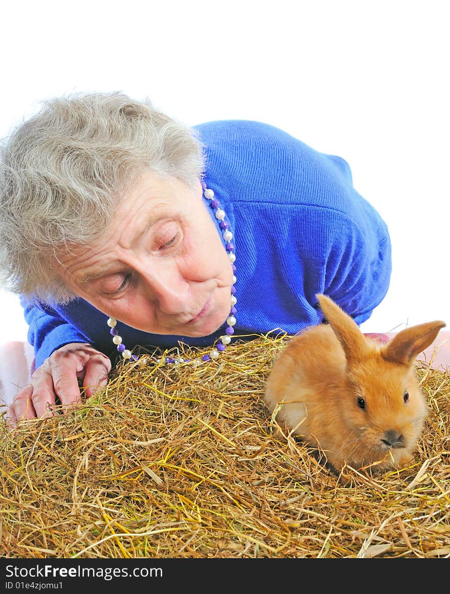 Elderly woman with one small rabbit. Elderly woman with one small rabbit