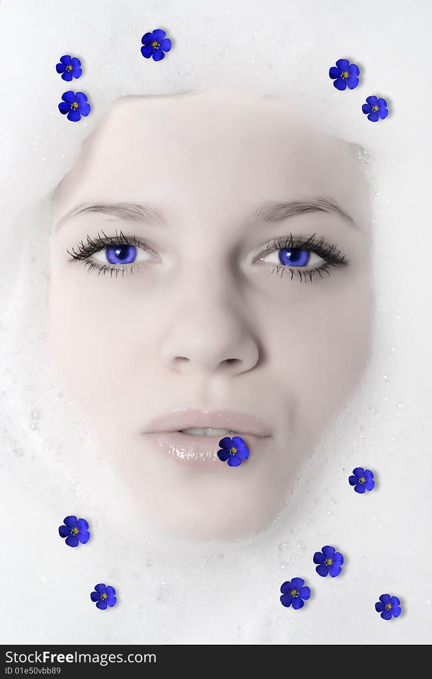 Face of a beautiful woman in white foam with violet. Face of a beautiful woman in white foam with violet