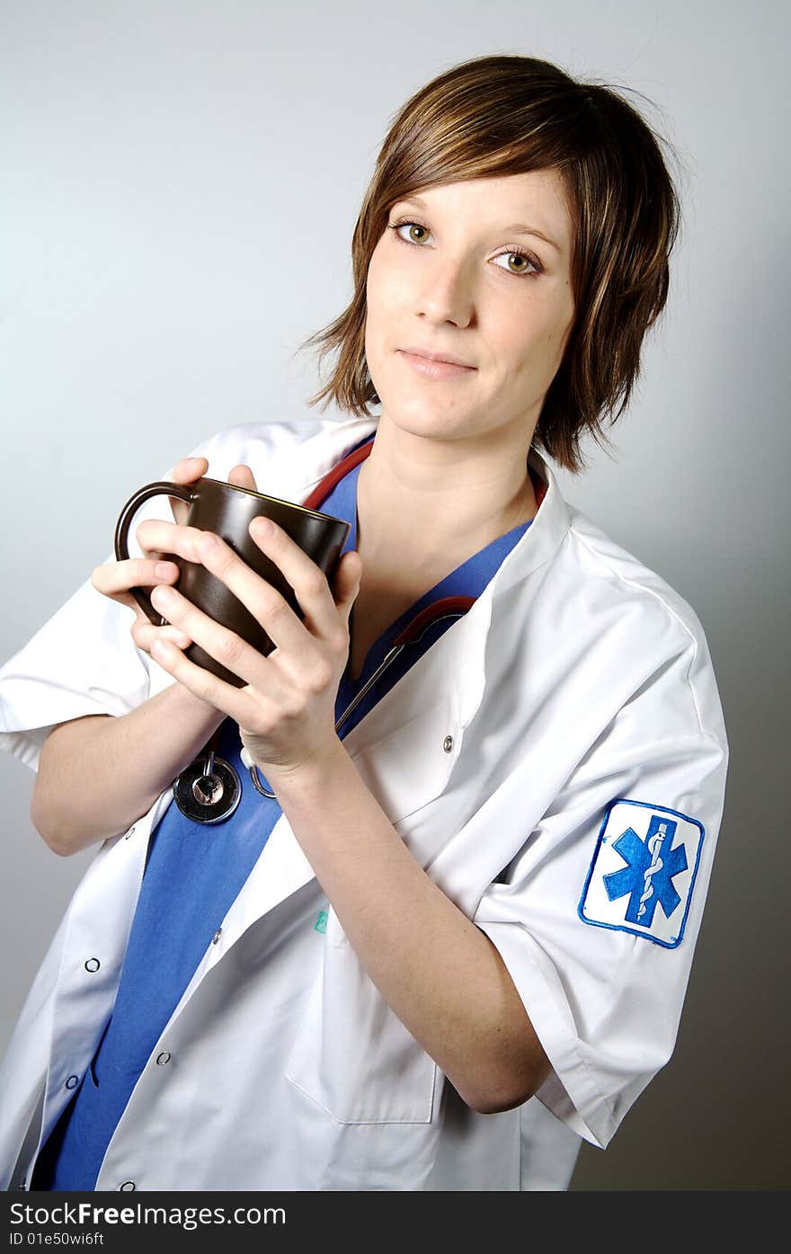 Nurse or doctor holding a cup of coffee on a white blackground. Nurse or doctor holding a cup of coffee on a white blackground