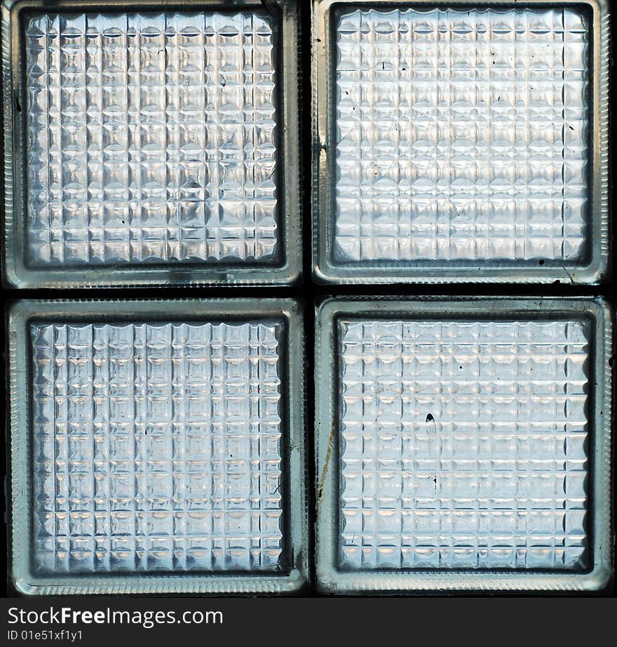 Four green-grey transparent textured glass blocks. Four green-grey transparent textured glass blocks