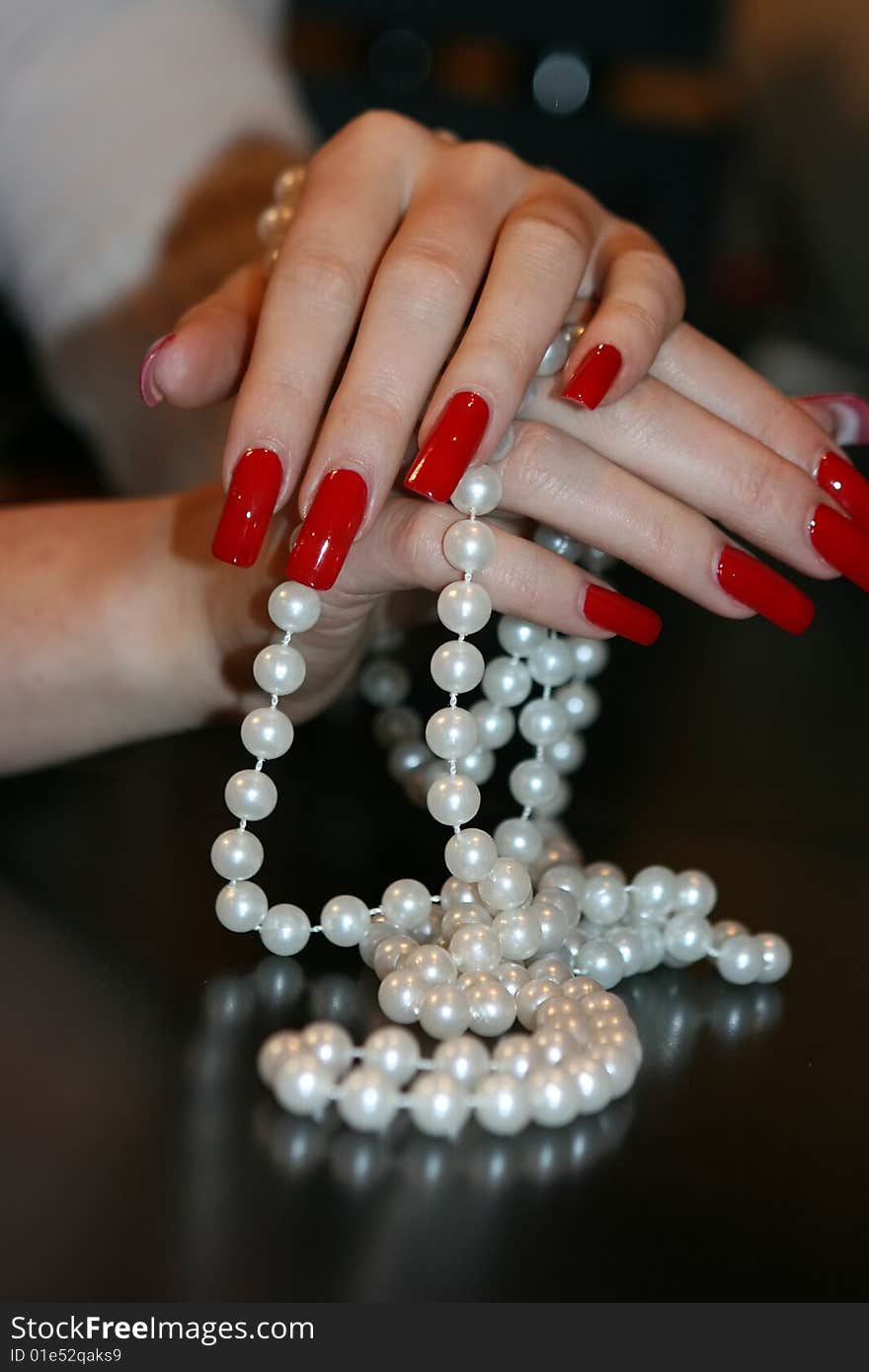 Girl holding a pearl necklace in her hands