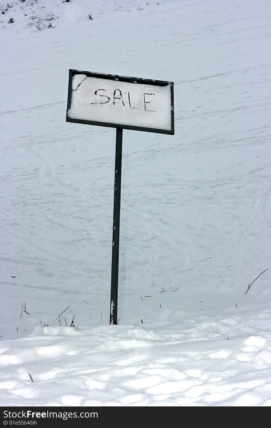 Sale sign standing on the snow