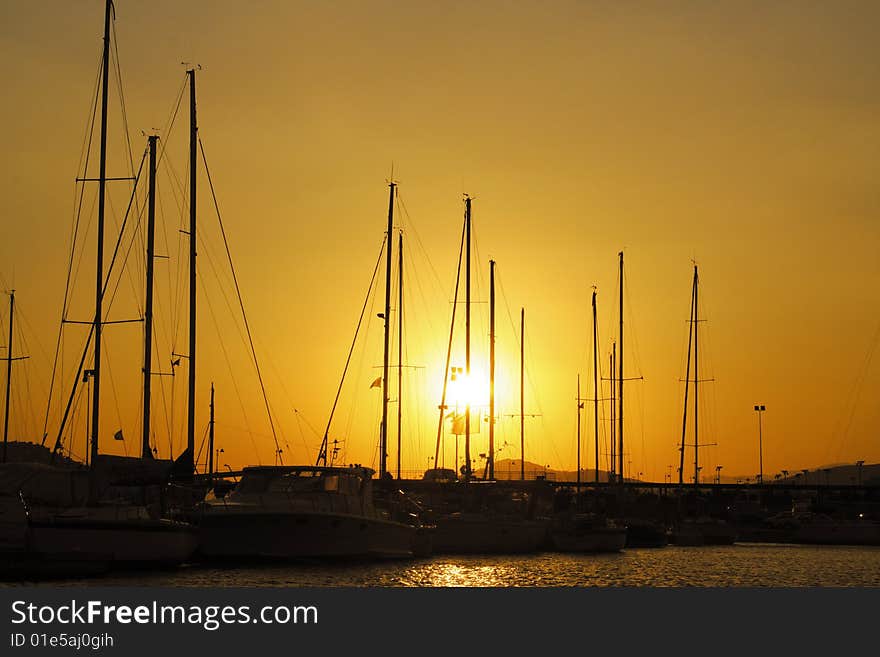 Sun setting behind a marina in Greece. Sun setting behind a marina in Greece