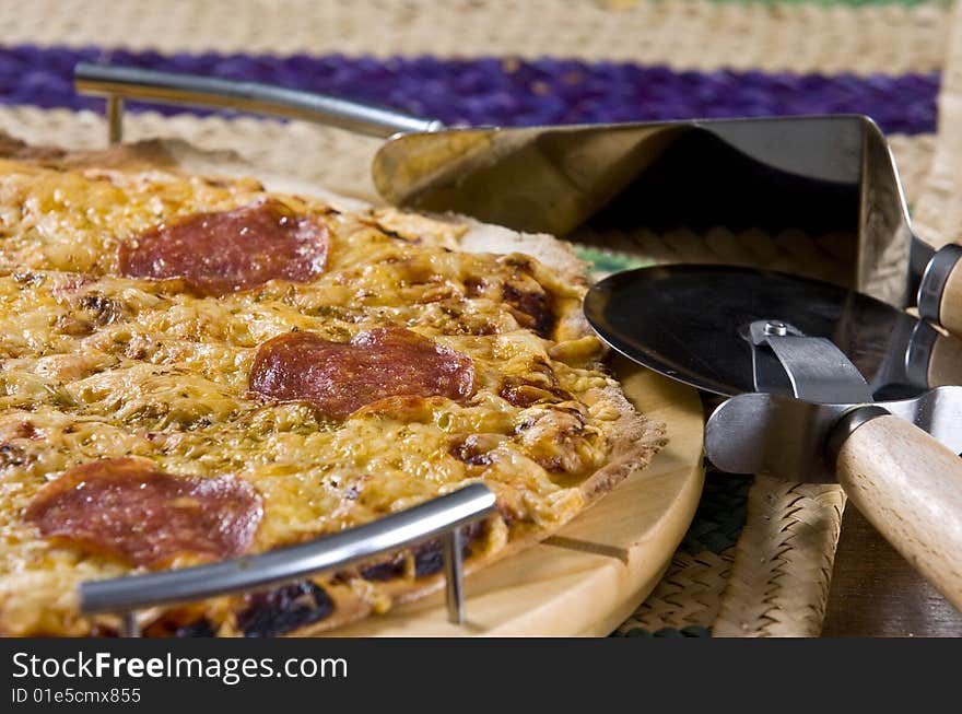 Peperoni pizza served on wooden board