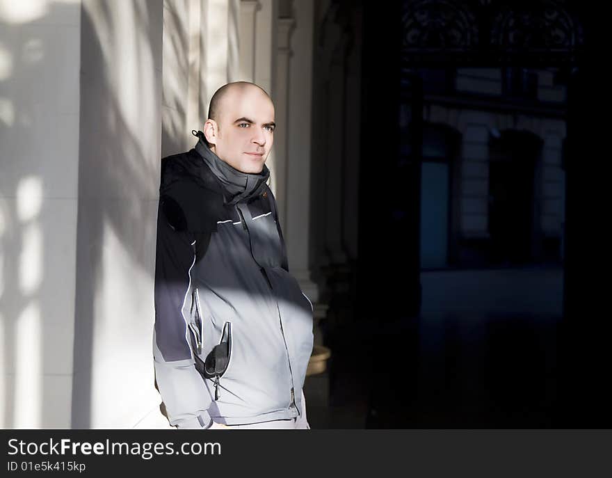 Man Portrait Near The White Wall. Man Portrait Near The White Wall