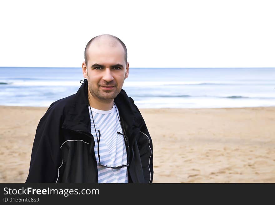 Man Close-Up Portrait On The Ocean Background. Man Close-Up Portrait On The Ocean Background