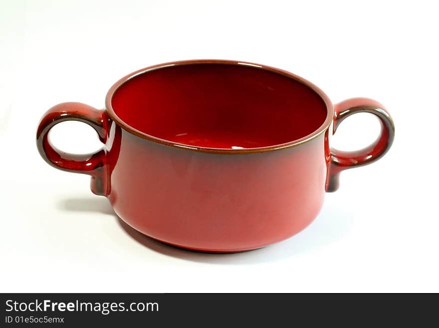 Red bowl is isolated on a white background