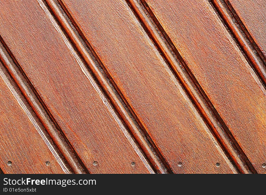 Fragment of old brown painted wooden gate. Fragment of old brown painted wooden gate