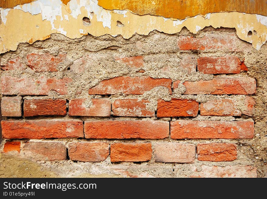 Fragment of tumbledown plastered brick wall. Fragment of tumbledown plastered brick wall