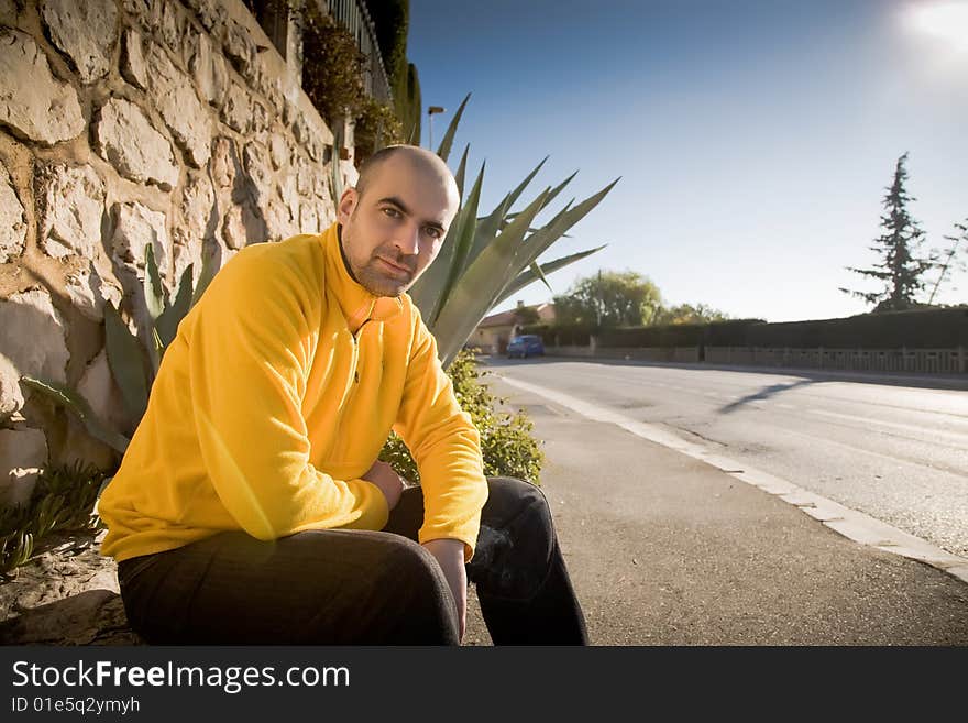 Man Sitting Near The Road. Europe Travel Series. Man Sitting Near The Road. Europe Travel Series.