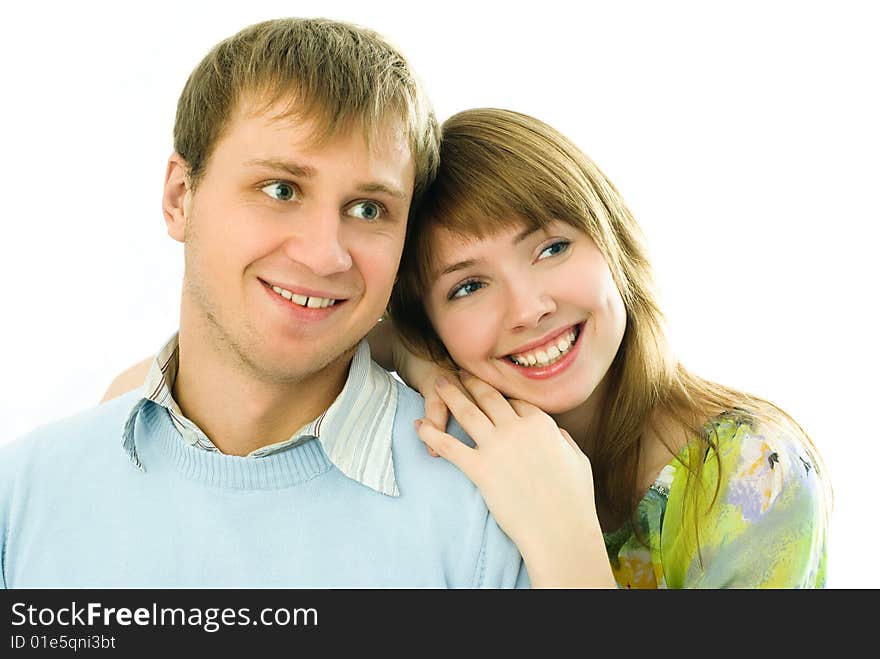 Happy young embracing and laughing couple against white background. Happy young embracing and laughing couple against white background