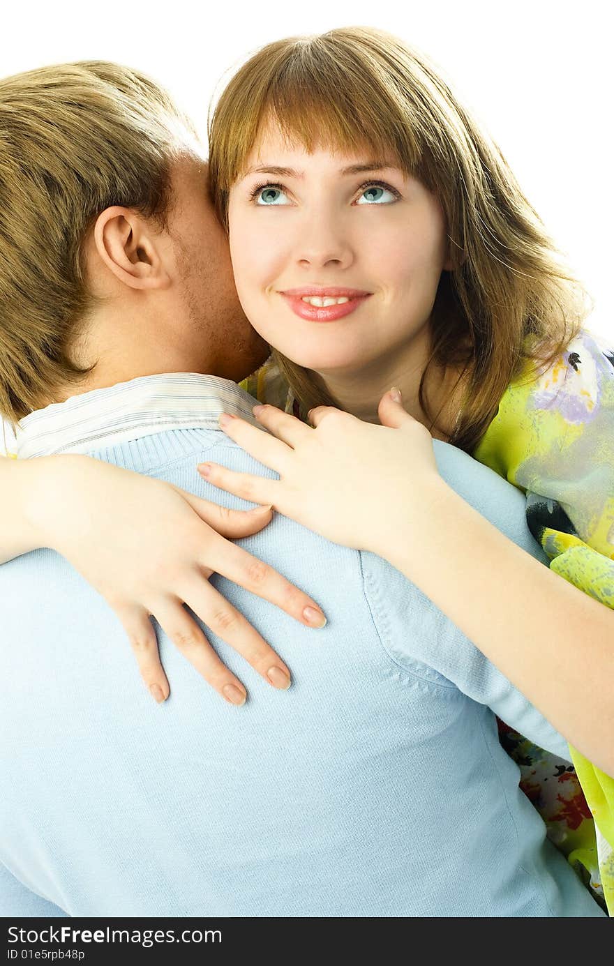 Happy couple, a dreamy young woman embraces her man and smiles. Happy couple, a dreamy young woman embraces her man and smiles