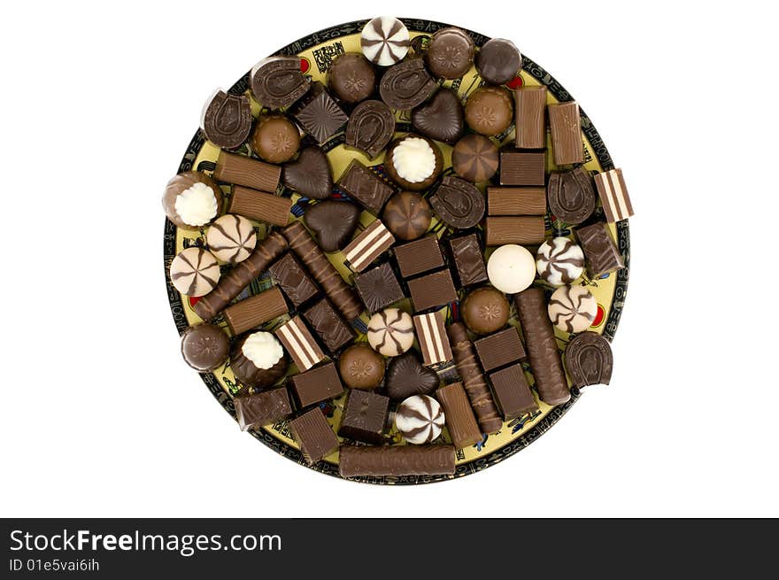 Chocolate sweets on dish , isolated