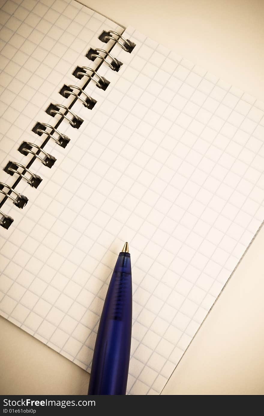 Notebook with blue pen on it. Notebook with blue pen on it