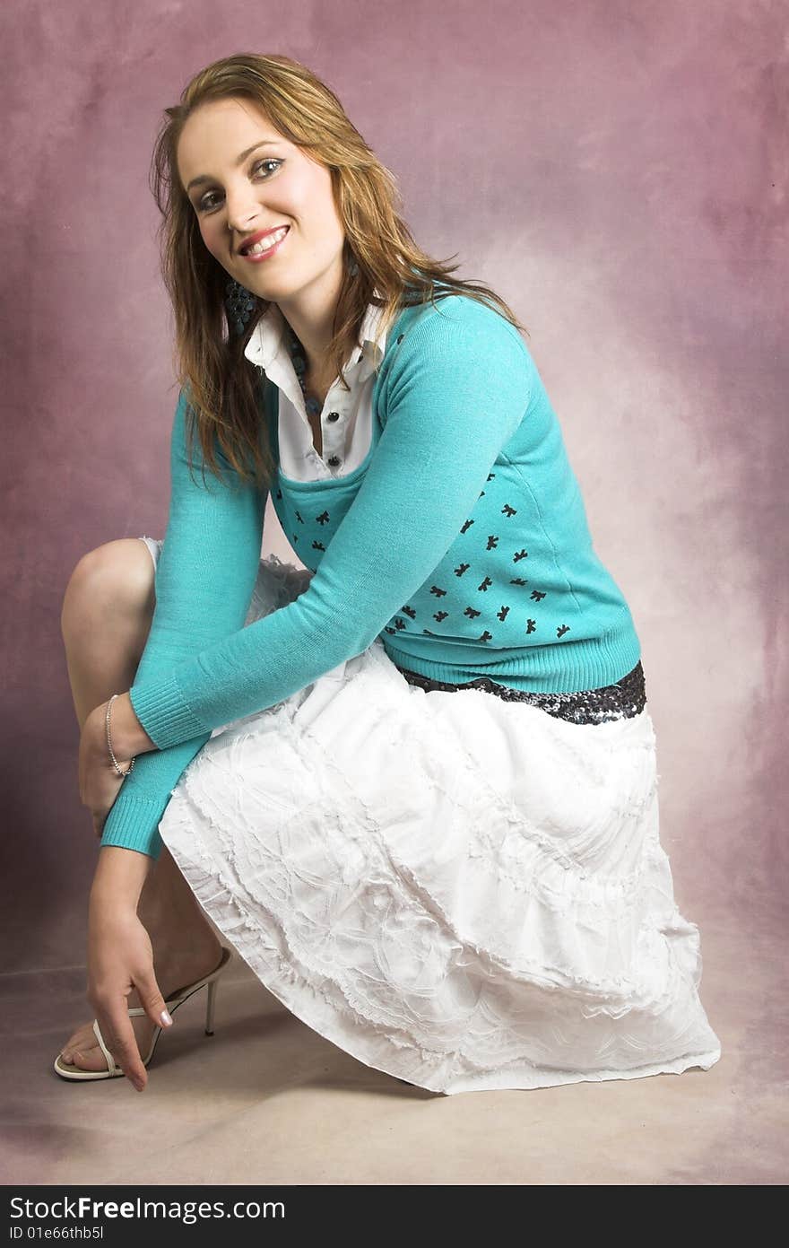 Beautiful young female wearing a white skirt and blue top