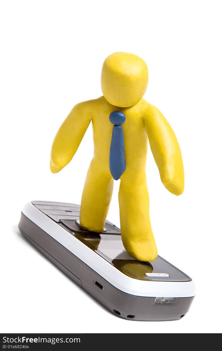 Plasticine man standing on mobile phone like surfer isolated on white