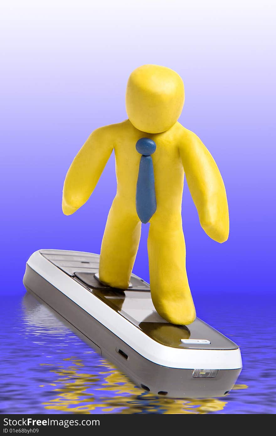 Plasticine man standing on mobile phone like surfer in blue water with reflections