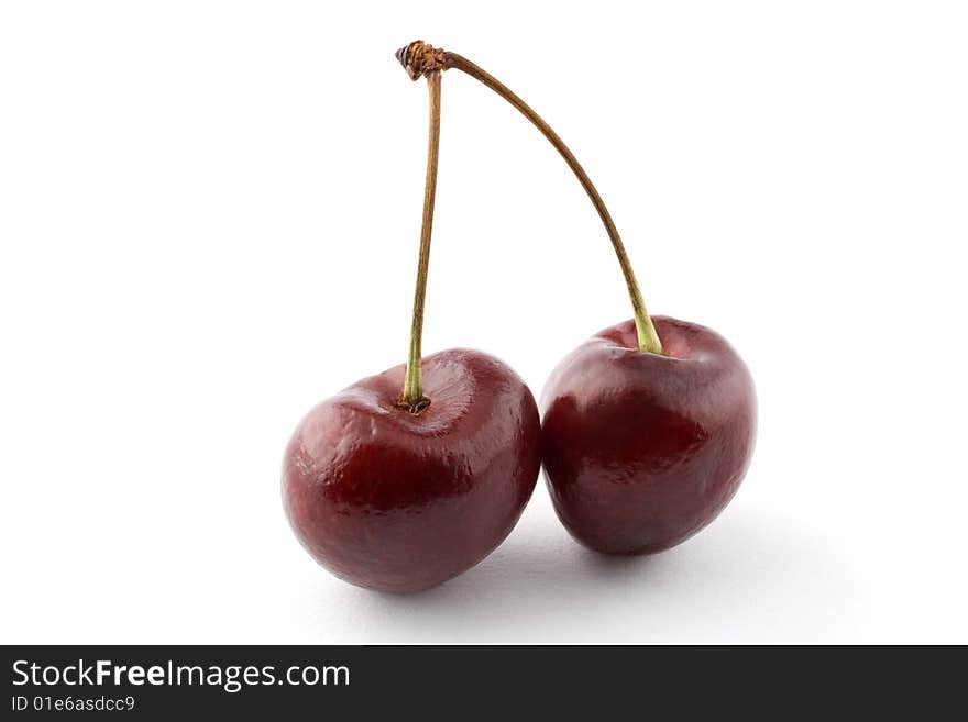 A pair of cherries isolated against a white background