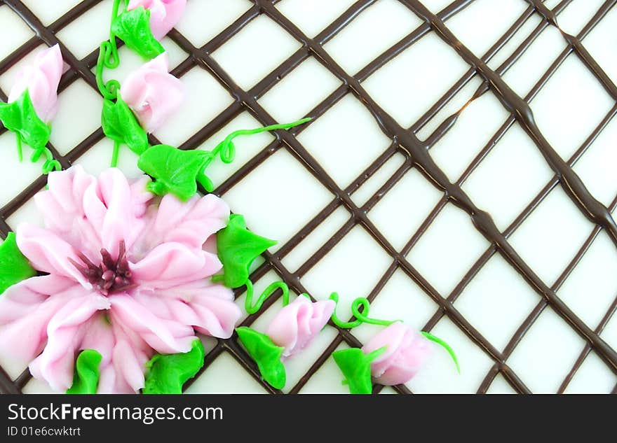 Frosting from top of cake in the shapes of pink flowers