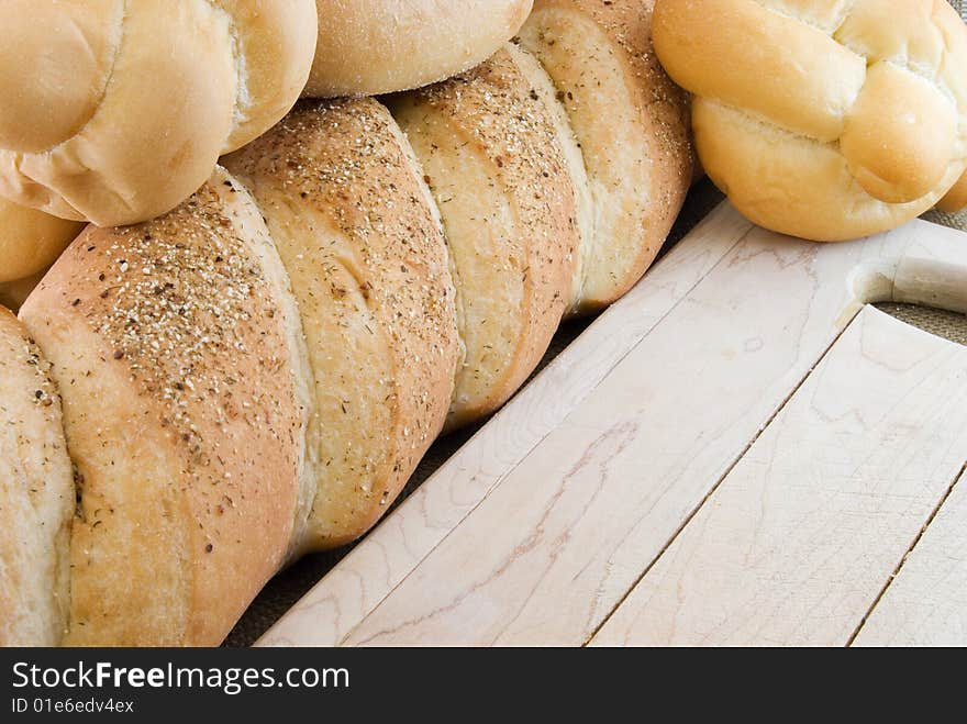 Various breads next to a cutting board