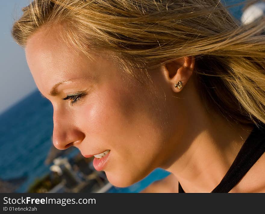 Blonde Female Looking Into Sun In Resort