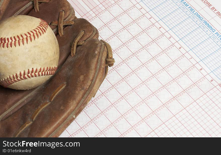 A picture of a ball and glove on a scorebook. A picture of a ball and glove on a scorebook