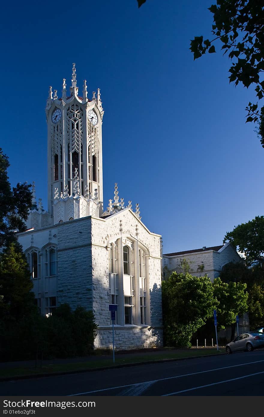 A white detailed church under blue sky