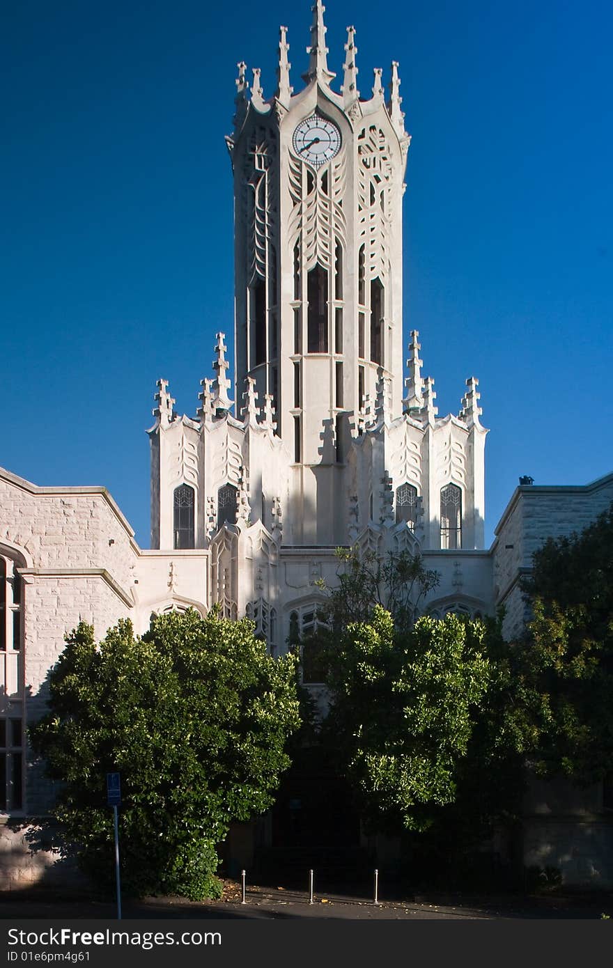 A white detailed church under blue sky