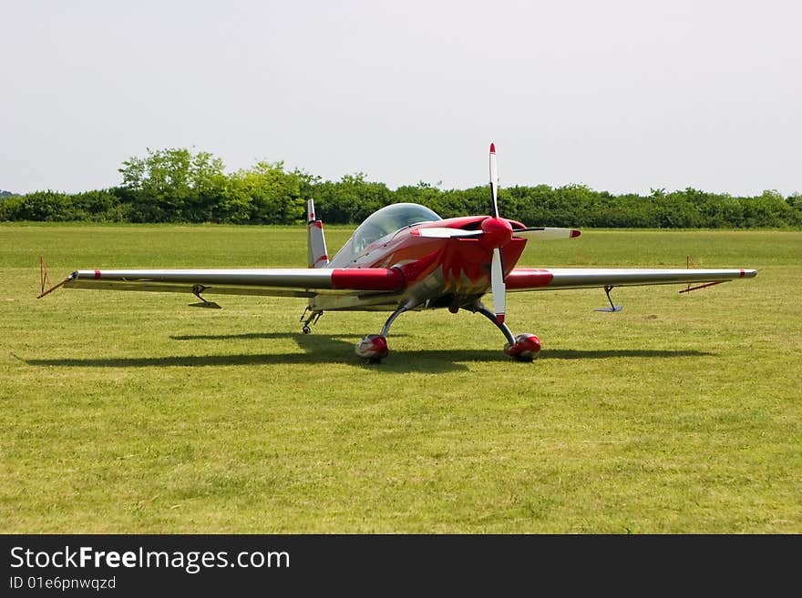 Sports plane on an airshow, on grassy runway.