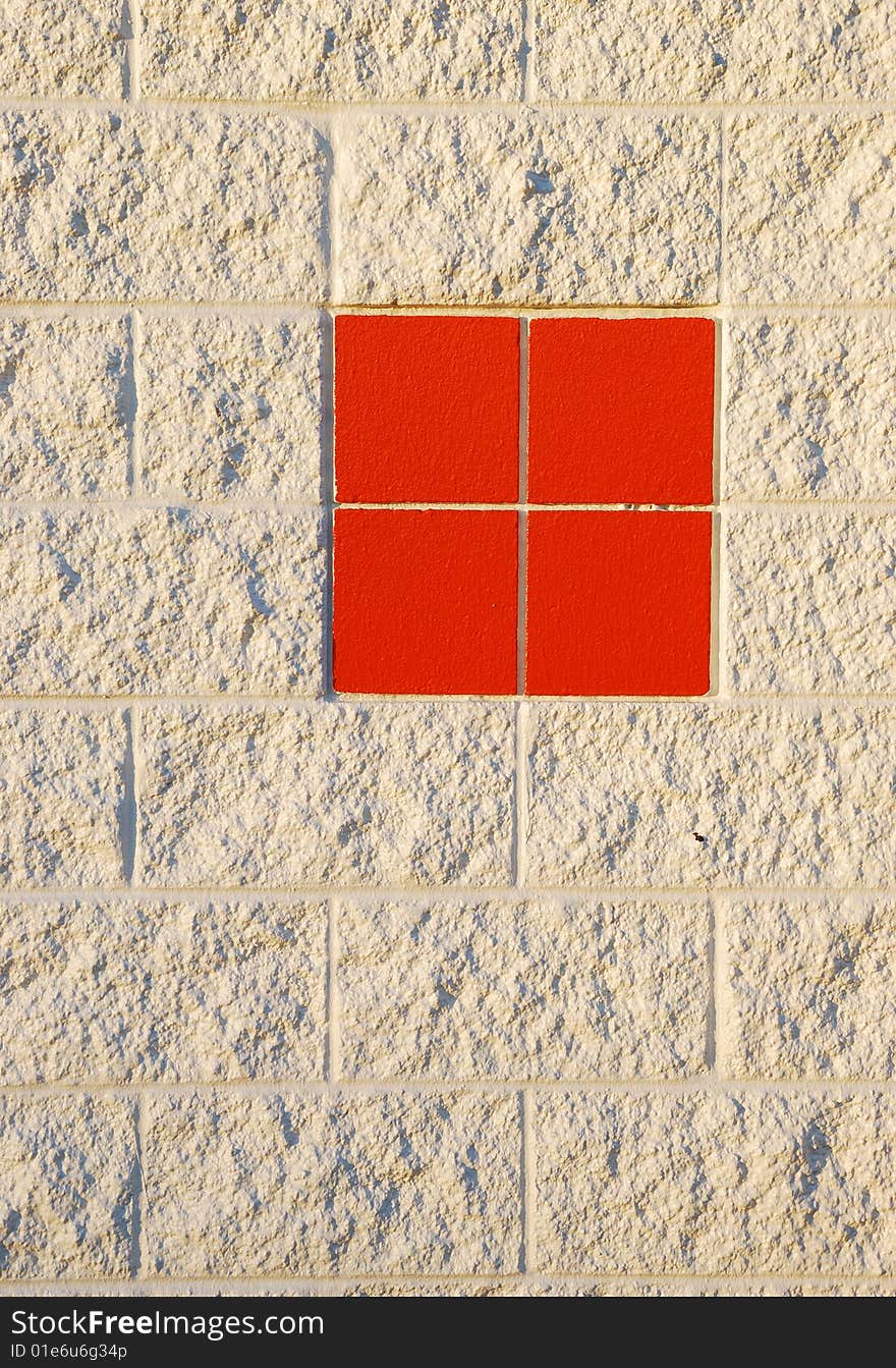 Close view of the brick wall with red tiles. Close view of the brick wall with red tiles